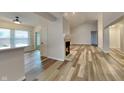 Spacious living room offers wood floors, large windows, and view into open kitchen at 7859 Chesapeake E Dr, Indianapolis, IN 46236
