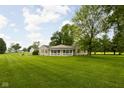 Inviting single-story home with a well-manicured lawn and a welcoming front porch, ideal for relaxation at 7990 S County Road 200 E, Pittsboro, IN 46167