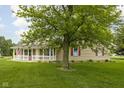 Attractive home with a lovely yard and a cozy front porch, creating a warm and inviting atmosphere at 7990 S County Road 200 E, Pittsboro, IN 46167