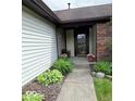 Inviting front porch adorned with charming plants and landscaping at 8123 Summertree Ct, Indianapolis, IN 46256