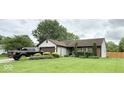 Well maintained home with neat landscaping, green lawn, and a dark truck parked in the driveway at 8123 Summertree Ct, Indianapolis, IN 46256