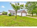Well-maintained single-story home featuring brick and vinyl siding, blue shutters, and a spacious front lawn at 8684 Captain Dr, Avon, IN 46123