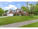 Beautiful brick two-story home featuring an attached two-car garage and a well-manicured lawn at 8723 Bergeson Dr, Indianapolis, IN 46278
