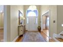 Inviting foyer with hardwood floors, an arched doorway, and a chandelier hanging from the ceiling at 8723 Bergeson Dr, Indianapolis, IN 46278