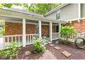Charming covered porch with brick columns, stepping stones, and garden bed at 8934 Pinyon Ct, Indianapolis, IN 46260
