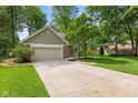 Well-maintained front yard featuring an attached garage and a concrete driveway at 8934 Pinyon Ct, Indianapolis, IN 46260