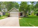 Charming two-story home featuring an attached garage and a well-manicured lawn at 8934 Pinyon Ct, Indianapolis, IN 46260
