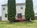 View of the wood deck in the backyard with grass and trees at 8939 Newchurch Blvd, Indianapolis, IN 46231