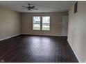 Bright living room with ceiling fan, hardwood floors, and neutral paint at 901 Westpointe Dr, Shelbyville, IN 46176