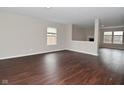 Spacious living room with dark wood floors and neutral walls, creating a warm and inviting atmosphere at 9206 Huntleigh Cir, Plainfield, IN 46168