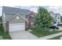 Two-story home featuring brick and shingle exterior, an attached garage, and well-maintained lawn with a tree at 935 Northwich Ave, Westfield, IN 46074