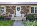 Close up of front door showing brickwork, sidelight windows and decorative wreath at 9390 N State Road 39, Lizton, IN 46149