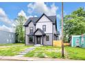 Charming two-story home with a beautifully landscaped yard and inviting exterior, perfect for modern living at 1027 Hosbrook St, Indianapolis, IN 46203