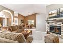 Open-concept living space with a cozy fireplace, dining area, and comfortable seating at 10759 Sawgrass Dr, Fishers, IN 46037