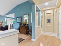 Bright foyer featuring hardwood floors, neutral paint, and transitional decor at 11510 Monon Farms Ln, Carmel, IN 46032