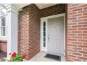 Inviting entryway with a classic white door and red brick facade at 11510 Monon Farms Ln, Carmel, IN 46032