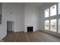 Bright living room with a fireplace, high ceilings, and lots of natural light at 12403 Fresh Stock Dr, Noblesville, IN 46060
