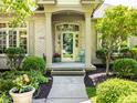 Inviting front porch with decorative columns and a charming entry, enhancing the home's welcoming ambiance at 13069 Abraham Run, Carmel, IN 46033