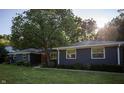 Charming blue home featuring a well-maintained front yard, mature tree and beautiful landscaping at 1309 Rolling Ct, Westfield, IN 46074