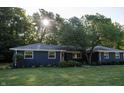 Charming blue home featuring a well-maintained front yard, mature tree and beautiful landscaping at 1309 Rolling Ct, Westfield, IN 46074