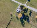 Expansive aerial view showcasing the property's lot with mature trees, bordering open fields at 13518 Promise Rd, Fishers, IN 46038