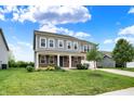 Charming two-story home featuring gray siding, brick accents, a well-manicured lawn, and an attached two-car garage at 1384 Horse Shoe, Greenwood, IN 46143