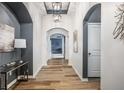 Elegant hallway featuring arched doorways, stylish console table, and decorative artwork on display at 15596 Edenvale Dr, Westfield, IN 46074