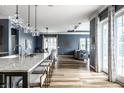 Open-concept kitchen featuring a large island with seating, pendant lighting, and access to the backyard at 15596 Edenvale Dr, Westfield, IN 46074