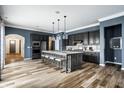Modern kitchen featuring a large island with seating, pendant lighting, and sleek appliances at 15596 Edenvale Dr, Westfield, IN 46074