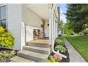 Cozy front porch with seating and lush landscaping at 170 W Broadway St, Greenwood, IN 46142