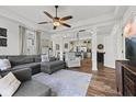 Open-concept living room with views of the kitchen, dining area, and hardwood floors at 170 W Broadway St, Greenwood, IN 46142