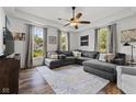 Spacious living room with large windows, ceiling fan, and hardwood flooring at 170 W Broadway St, Greenwood, IN 46142