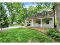 Inviting home with a cozy covered porch and well-maintained front yard landscaping at 1725 W 53Rd St, Indianapolis, IN 46228
