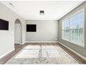 Bright living room with large window, neutral paint, and hardwood flooring at 1843 Winchester Blvd, Avon, IN 46123