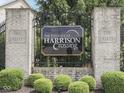 The Estates at Harrison Crossing entrance sign with manicured bushes and brick pillars at 187 N Bend Dr, Greenwood, IN 46142