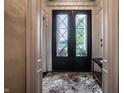 Grand foyer featuring patterned marble floors and a large glass-paneled front door at 1894 Rhettsbury St, Carmel, IN 46032