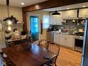 Functional kitchen space with modern appliances, bright cabinetry, and a wooden dining set near the entrance at 230 E Poplar St, Danville, IN 46122