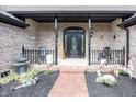Inviting front porch with brick path, decorative water fountain and exterior decorations at 28 Patriot Ct, Greenfield, IN 46140