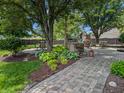 Outdoor patio area featuring brick pavers, lush landscaping, outdoor kitchen and dining at 319 Mcintosh Ln, Westfield, IN 46074