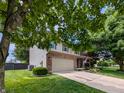 Charming two-story home featuring a well-manicured lawn, front porch and attached two car garage at 319 Mcintosh Ln, Westfield, IN 46074