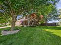 Expansive front yard featuring mature trees and manicured landscaping at this two-story home at 319 Mcintosh Ln, Westfield, IN 46074