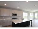 Modern kitchen featuring a large island, stainless steel appliances, and ample cabinet space at 4250 Ironclad Dr, Bargersville, IN 46106