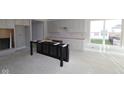 Bright kitchen features unfinished island, white cabinets and stainless appliances, offering modern elegance at 4250 Ironclad Dr, Bargersville, IN 46106