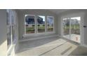 Sun-lit living room with large windows and sliding glass door, perfect for relaxing and entertaining at 4250 Ironclad Dr, Bargersville, IN 46106