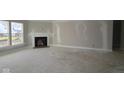 Spacious living room with modern fireplace and large windows, providing warmth and natural light at 4250 Ironclad Dr, Bargersville, IN 46106