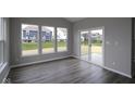 Sun-filled room with sliding glass door and plank flooring at 4250 Ironclad Dr, Bargersville, IN 46106