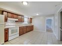 Functional kitchen with wooden cabinets and a bright white appliance suite at 4337 English Ave, Indianapolis, IN 46201