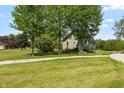 Idyllic home featuring lush greenery, a sprawling yard, and a charming setting for outdoor activities at 4450 N St Rd 39, Danville, IN 46122