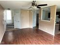 Spacious living room featuring wood floors, an open layout, and access to the kitchen and stairway at 4456 Redcliff N Ln, Plainfield, IN 46168