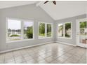 Sunroom featuring tile flooring and large windows overlooking a scenic water view at 4506 Tarragon Dr, Indianapolis, IN 46237